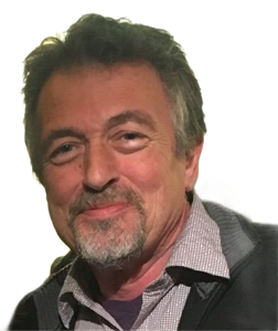 Jean-Luc Simon smily portrait, 67 years old, a little grey beard around his mouth. 